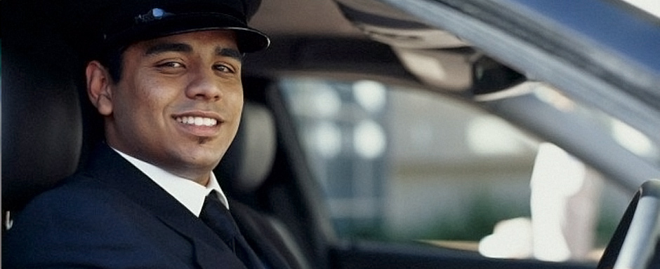 limo chauffeur dressed in a suit black hat white gloves