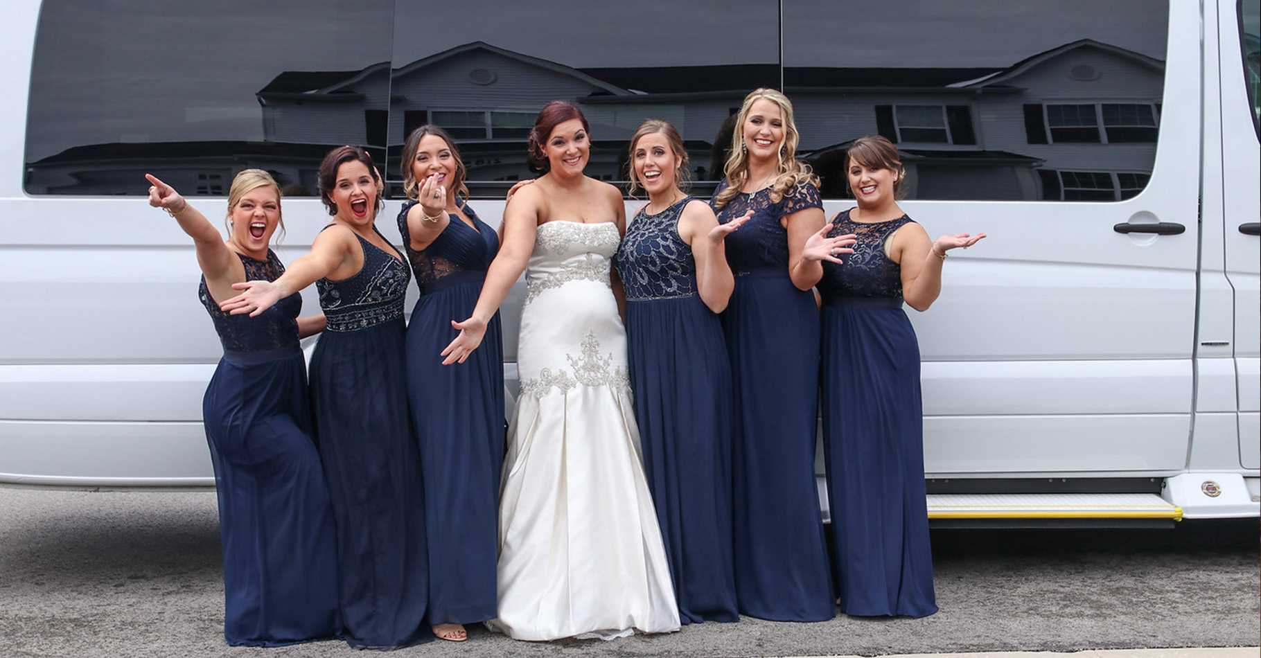 Bride and bridesmaids in front of a Chicago Mercedes mini party bus